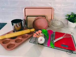 Essential baking tools, trays, spoons, tins, rack, thermometer