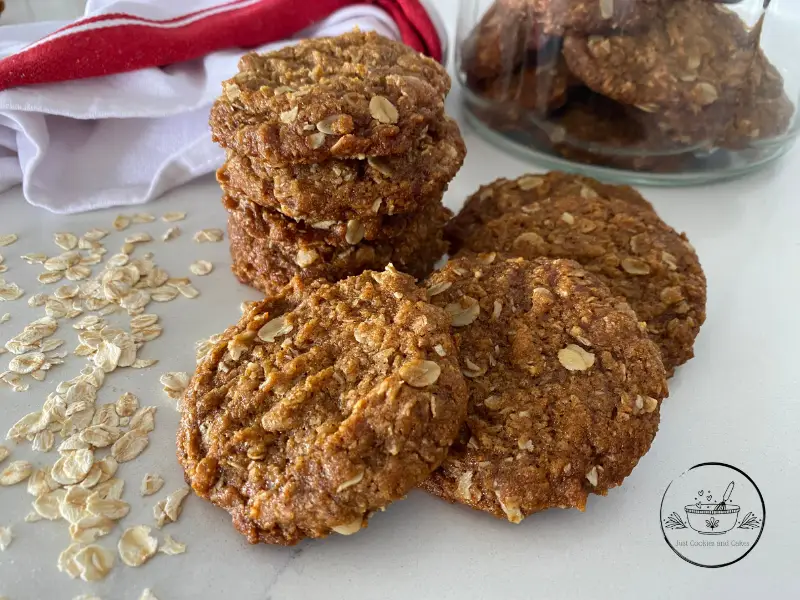 Anzac Biscuits on marble bench with red and white tea towel
